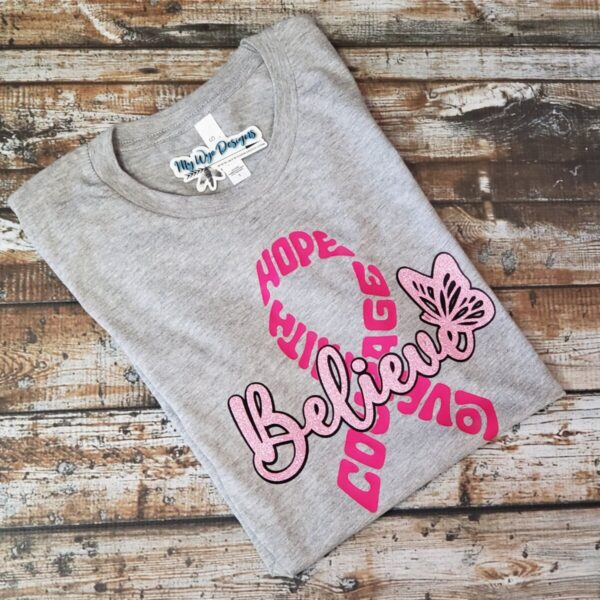 Shop Wyoming Don’t Stop Believing ~Buckin’ for a Cure~ Grey Tee